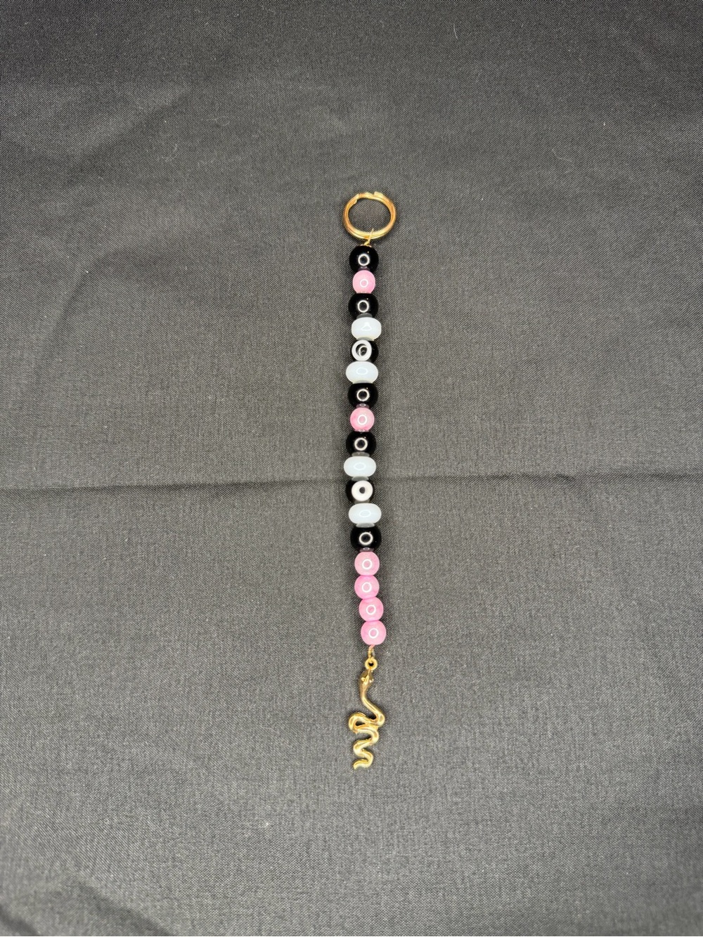 Evil eye black and pink with gold Snake charm